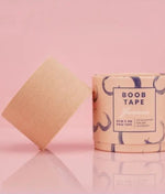 Boob tape with packaging on a pink background