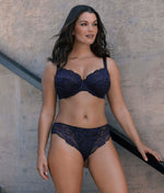 Woman wearing Fantasie bra and brief set against a neutral background