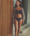 Model wearing Fantasie Reflect Underwired Bra and Brief set in Navy with open loose shirt